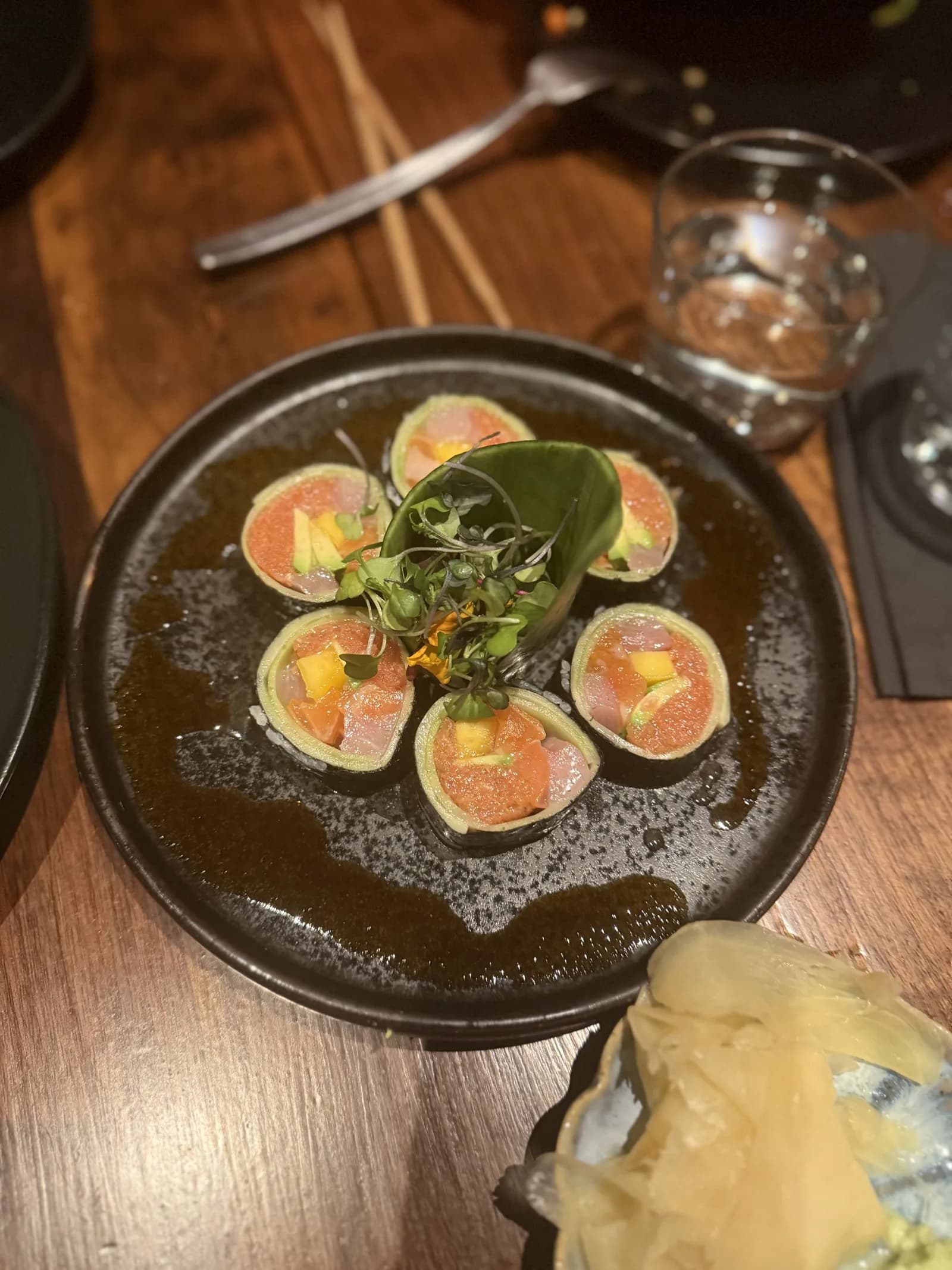 Azabu's Keto Roll: cucumber-wrapped rounds of tuna, salmon, mango and avocado with micro greens