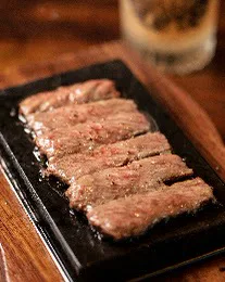 Japanese A5 Wagyu: marbled slices on a black stone